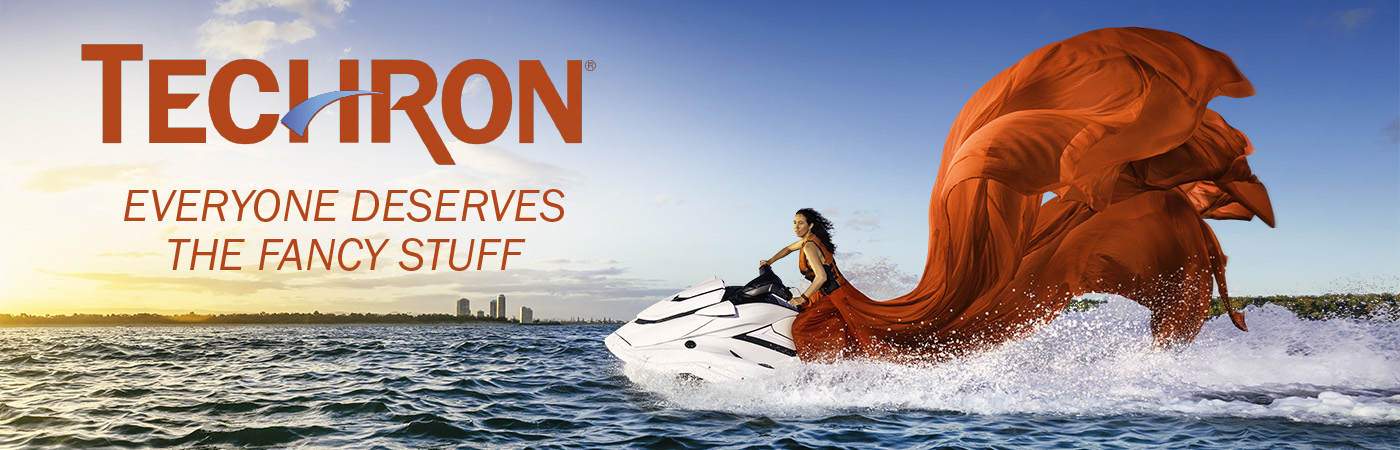 A brown-haired lady in a dazzling red ball gown, riding a jet ski through the gold coast waters, depicts the meaning of Caltex's 'Everyone Deserves the Fancy Stuff' slogan