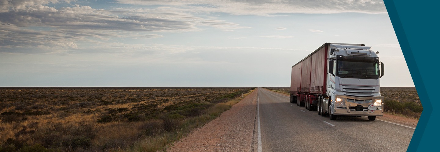 Blue container truck driving down road