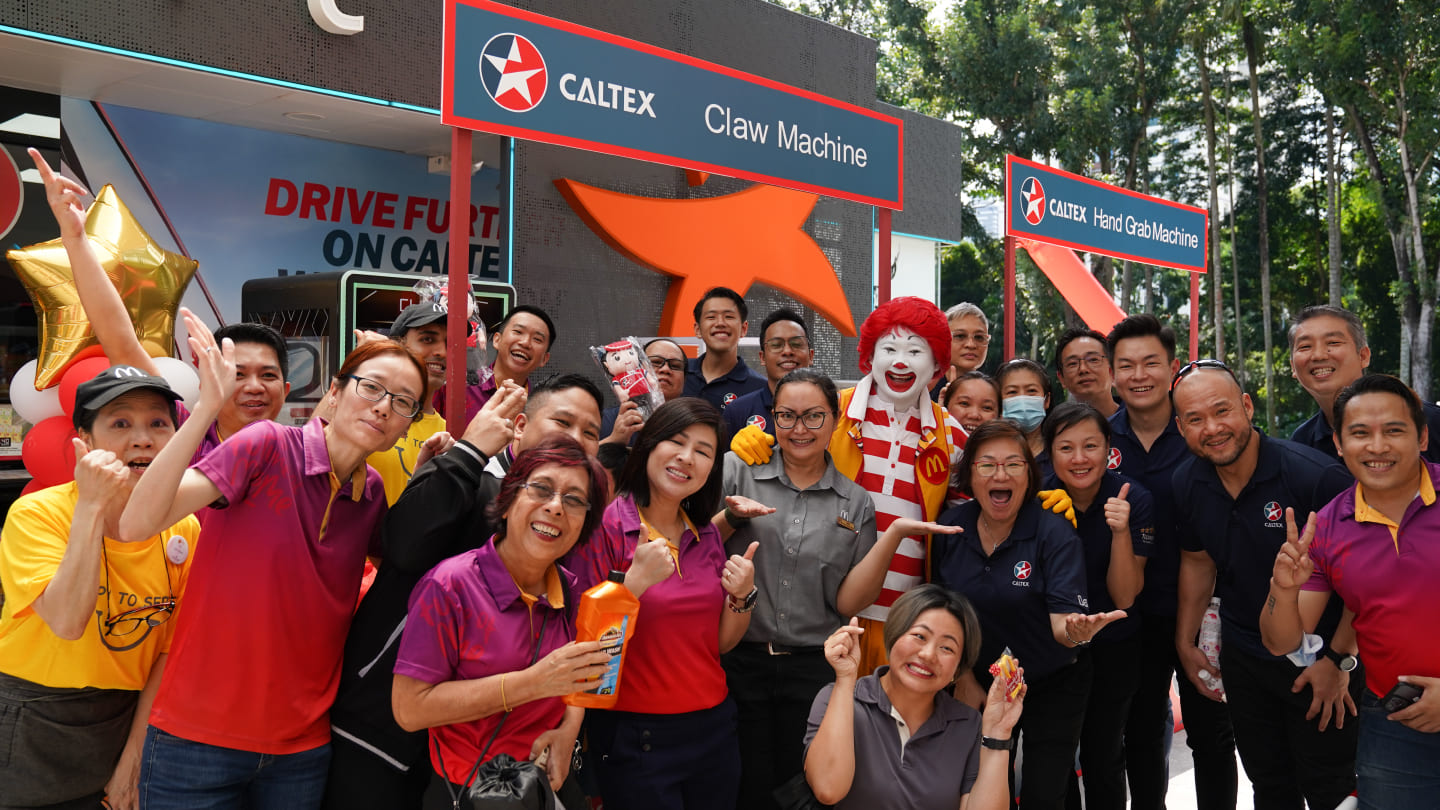 Caltex station staff with McDonalds staff and mascot