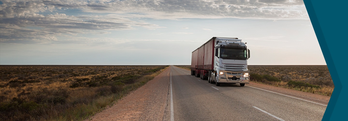 Red container truck driving down road