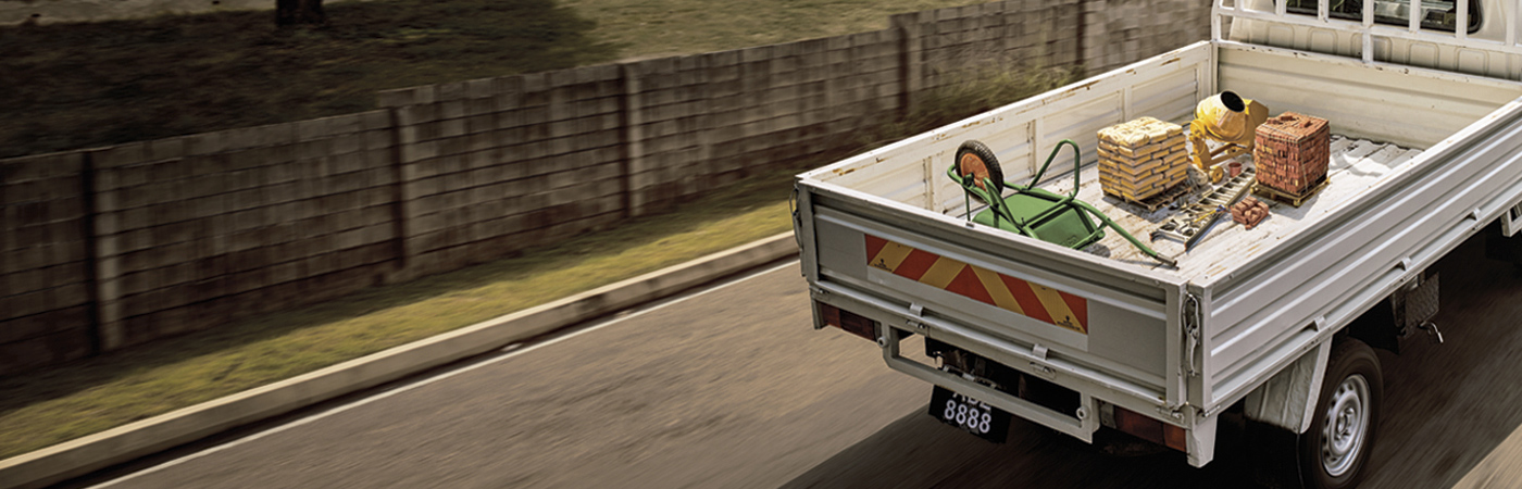 White pickup truck driving down a road with graphics suggesting high speed