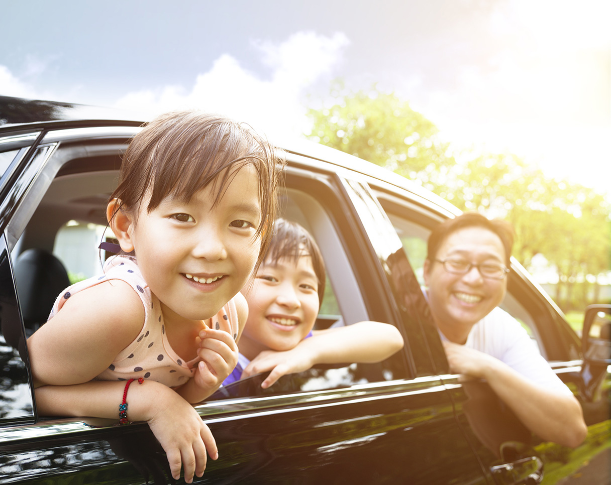 Family smiling through their car window