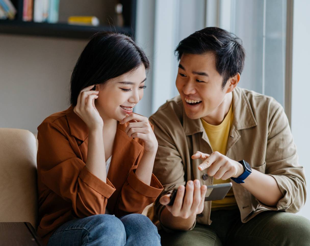 Couple looking at a mobile phone together