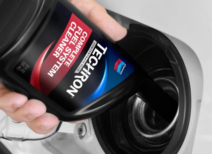 Close up of Techron® Concentrate Plus being poured into car